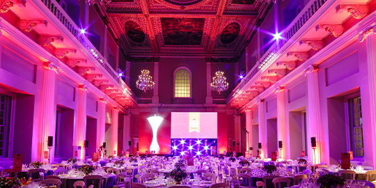 Banqueting house lit in pink and purples by Event Concept, a company specialised in event production (including event lighting and sound system), luxury event planning and management as well as video production and creative event designs.